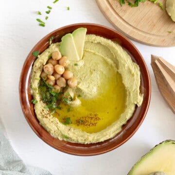 a bowl of creamy avocado hummus