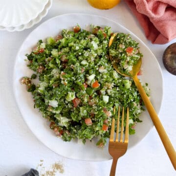 couscous tabbouleh in a plate and spoon with a fork on the side