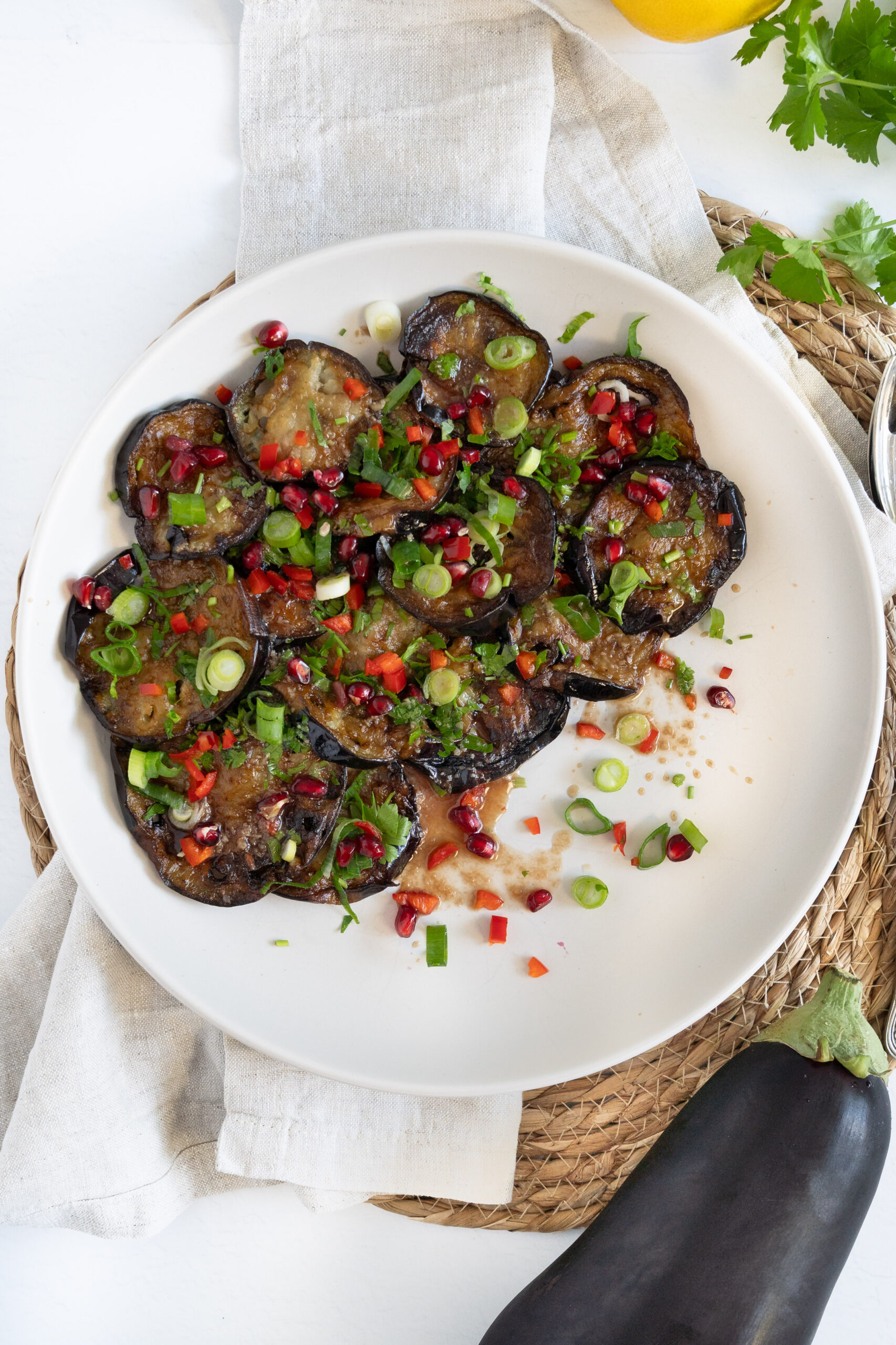 fried eggplant slices topped with dressing chopped herbs and chili