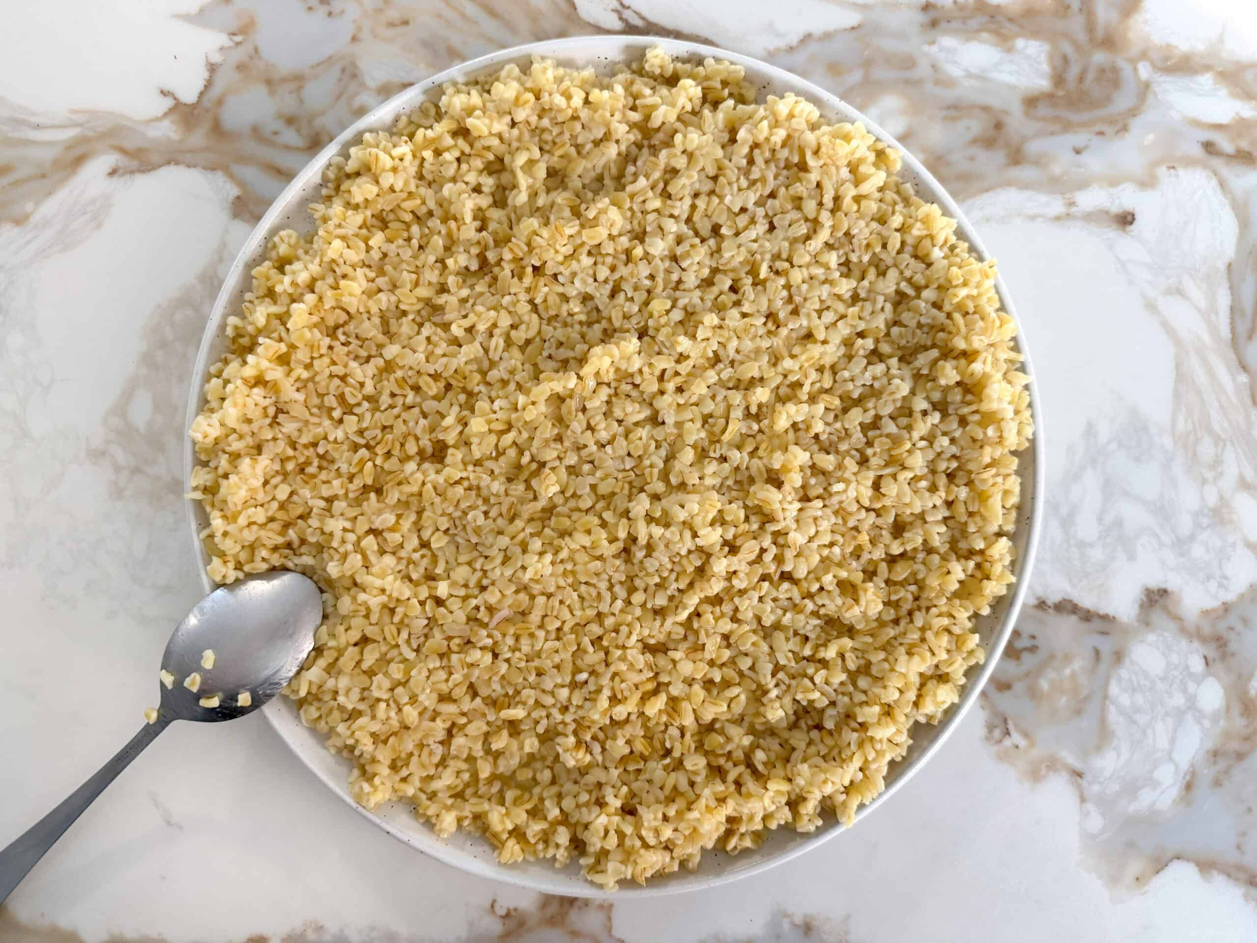 extra coarse cooked bulgur spread out in a plate