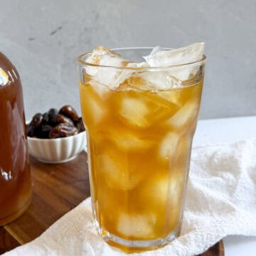 a cup of date juice with ice in it