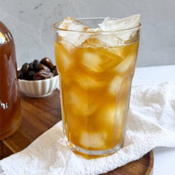 date juice in a tall glass with ice