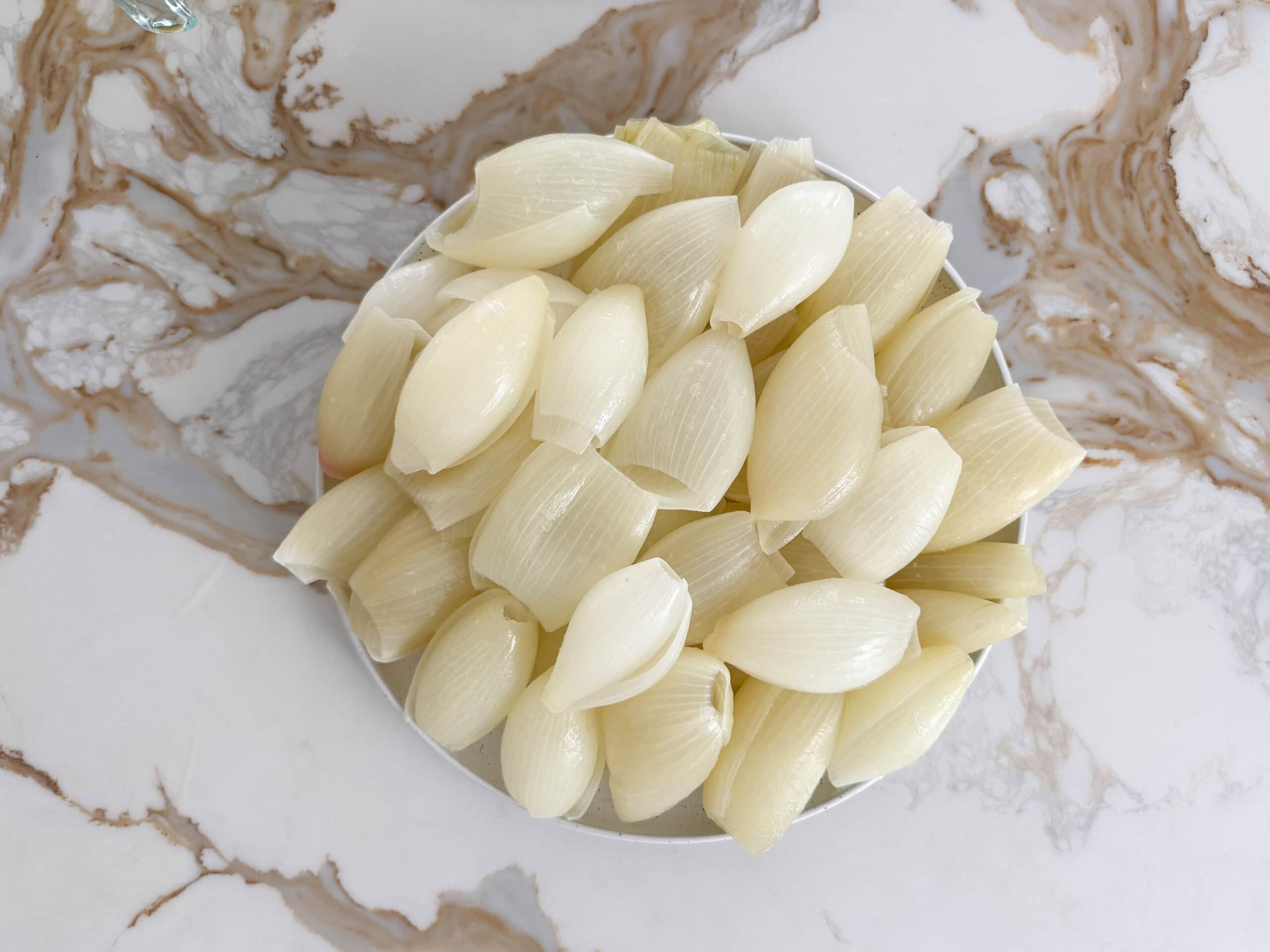 separate boiled onion layers in a plate
