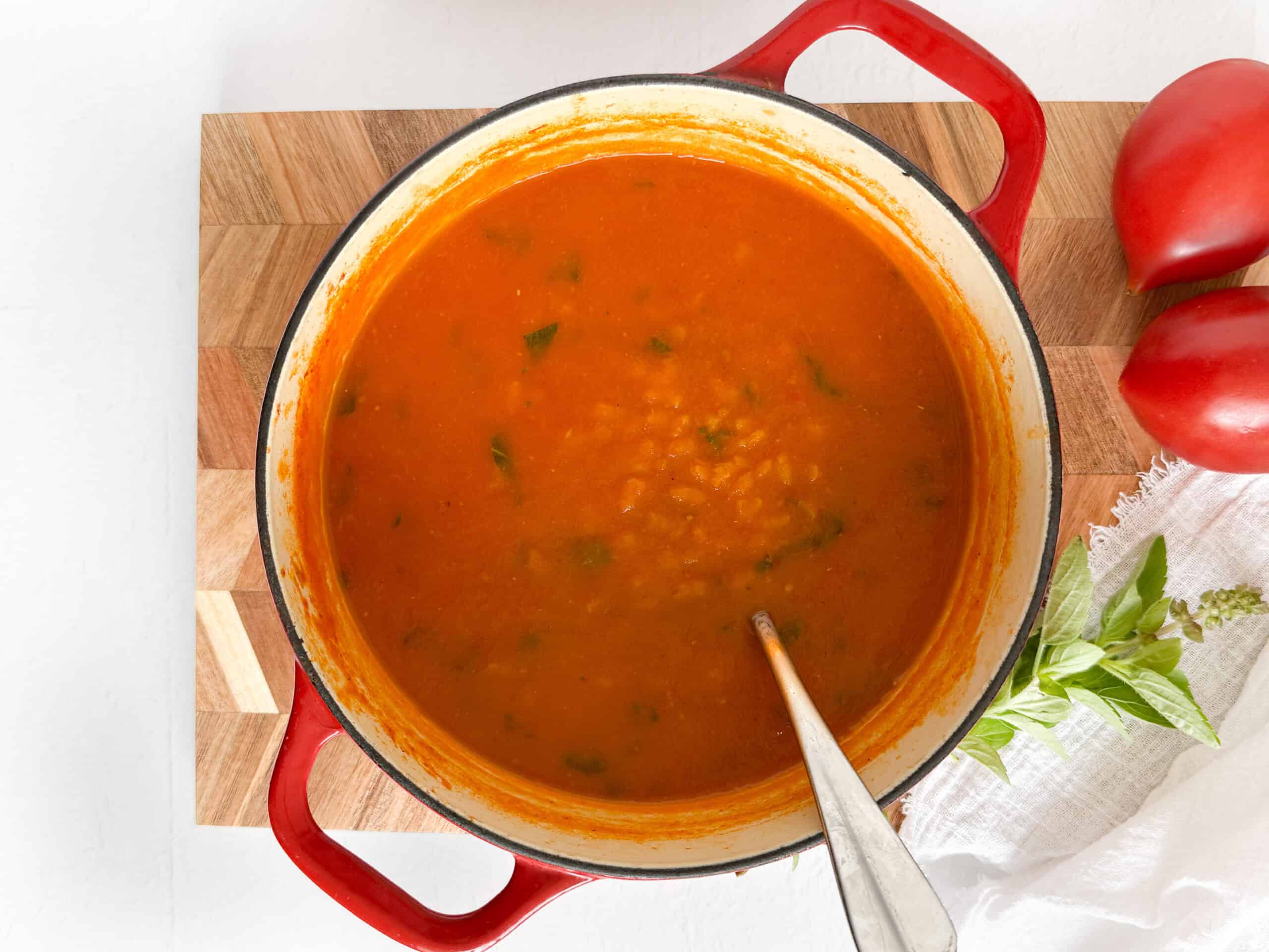 a pot full of tomato rice soup